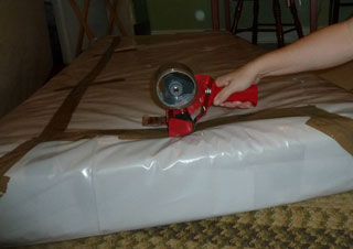 A woman seals her mattress