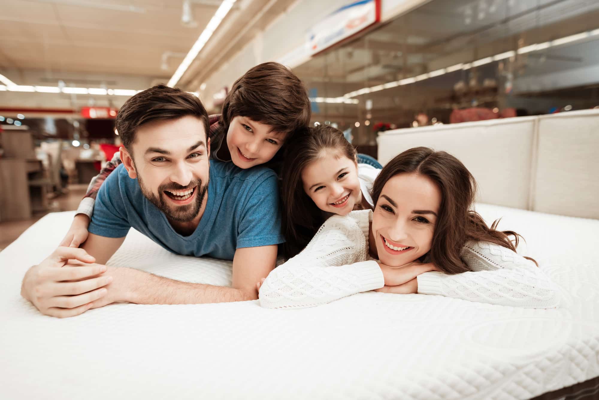 Parents and kids on a mattress